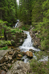Fototapeta na wymiar waterfall in deep forest at mountains