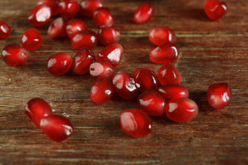 Juicy pomegranate on wooden table, closeup