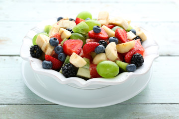 Fresh fruit salad on wooden table