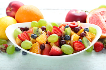 Fototapeta na wymiar Fresh fruit salad on wooden table
