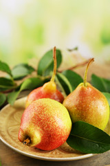 Fresh pears on wooden table on blurred background