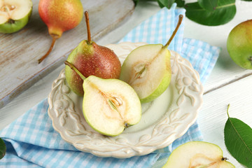 Fresh pears on wooden table with napkin, closeup