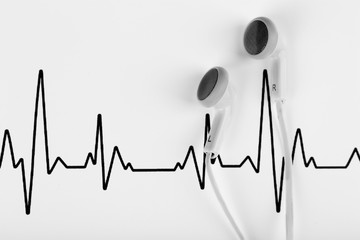 Earphones on cardiogram background