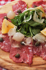Beef carpaccio with capers and rocket salad