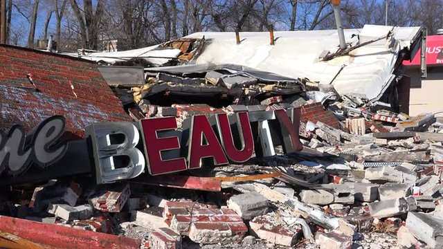 The ruins of a destroyed beauty salon following rioting  in Ferguson, Missouri make an ironic statement. 
