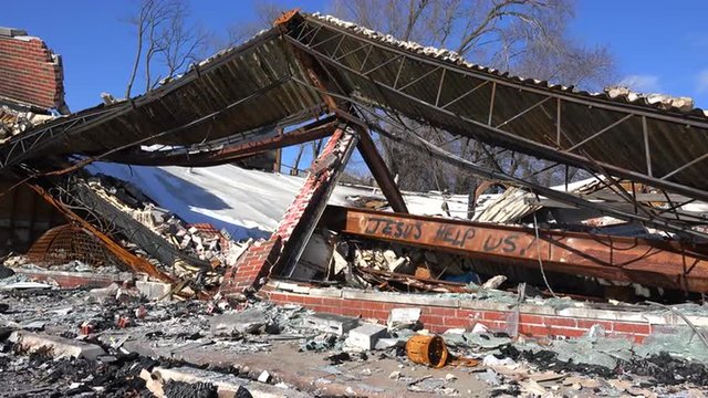 Graffiti decorates businesses abandoned and destroyed by the rioting in Ferguson, Missouri.