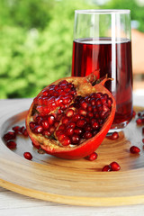 Fresh garnet juice with fruit on bright background