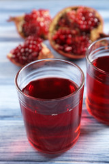 Fresh garnet juice with fruit on table close up