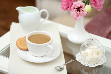 Cup of coffee on table in living room