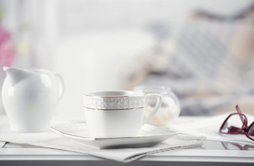 Cup of coffee on table in living room
