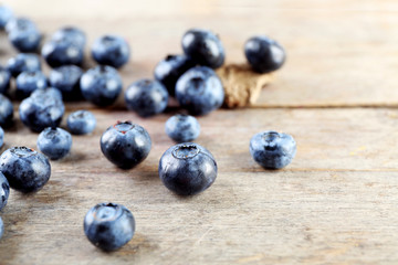Tasty ripe blueberries on wooden table close up