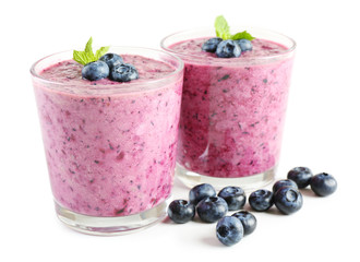 Glass of blueberry smoothie isolated on white
