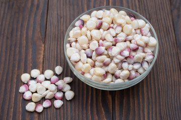 top view corn in glass bowl on wooden background