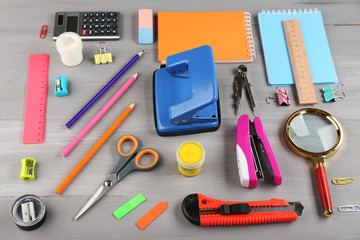 Bright stationery objects on wooden table close up