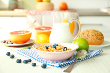 Healthy breakfast with fruits and berries on table in kitchen