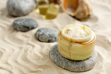 Stack of spa stones on sand background
