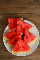 Slices of ripe watermelon on wooden table close up