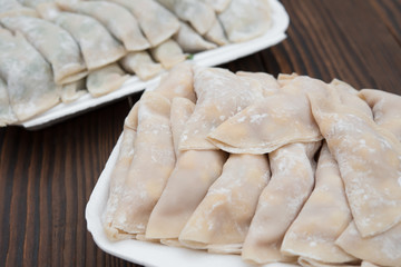 homemade dumpling filled with meat and corn on wooden board