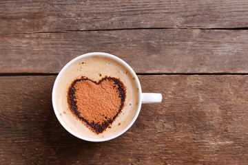 Cup of coffee on wooden background
