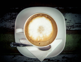 Coffee cup top view on old wooden