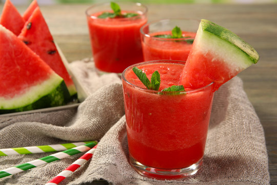 Glasses of watermelon juice on sackcloth, closeup