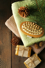 Handmade soap and cream with pine extract and spa treatments on wooden background