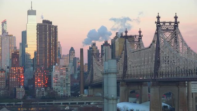 Beautiful shot of Manhattan New York skyline with Queensboro Bridge and Queens foreground at dusk or dawn.