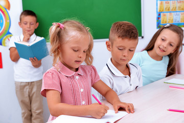 Group of children at the desk in classroom