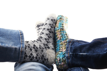 Human feet in knitted socks isolated on white