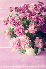 Beautiful purple chrysanthemum flowers on wooden table, closeup