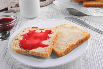 Bread with butter and homemade jam in plate, closeup