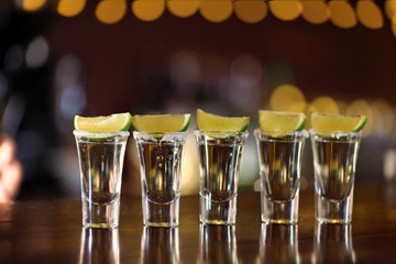 Shot glasses with tequila on bar counter