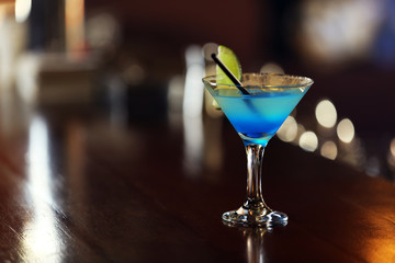 Cocktail on bar counter on bar background