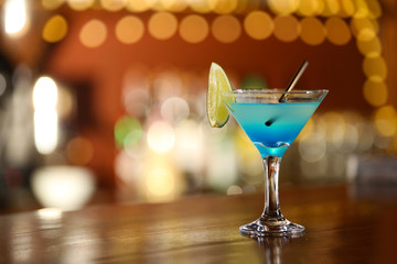 Cocktail on bar counter on bar background