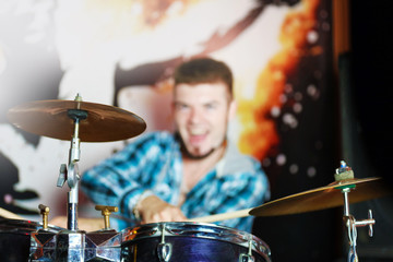 Excited drummer on bright background