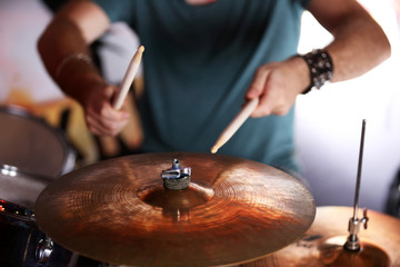 Hand of drummer  with sticks and drums, close-up