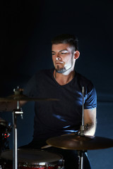 Drummer on dark background