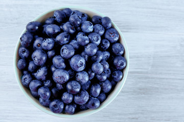 Fresh blueberries in bowl on table close up