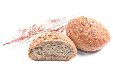 Fresh whole grain bread cut in half on white background
