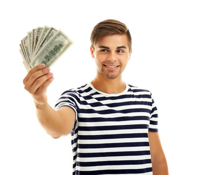 Handsome young man holding money isolated on white