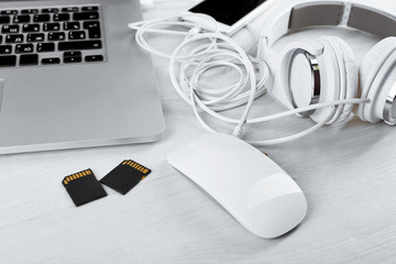 Computer peripherals and laptop accessories on white wooden background