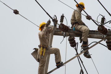 an electrical lineman working on a line