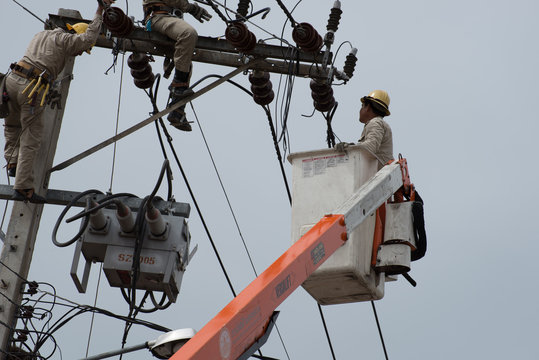 an electrical lineman working on a line