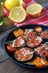 Baked vegetables in pan on wooden table