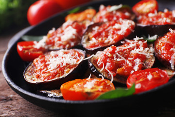 Baked vegetables in pan on wooden background