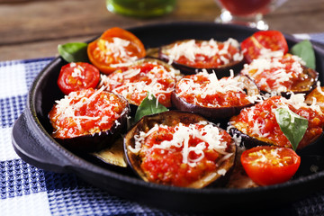 Baked vegetables in pan on table, close-up