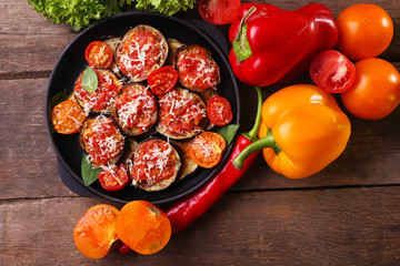 Baked and fresh vegetables on wooden table