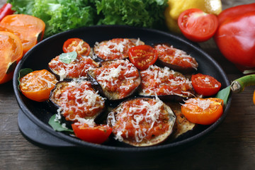 Baked and fresh vegetables on wooden table