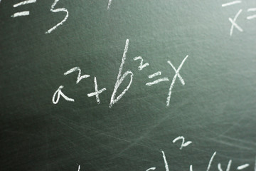 Maths formulas on chalkboard background