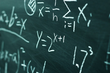 Fototapeta na wymiar Maths formulas on chalkboard background